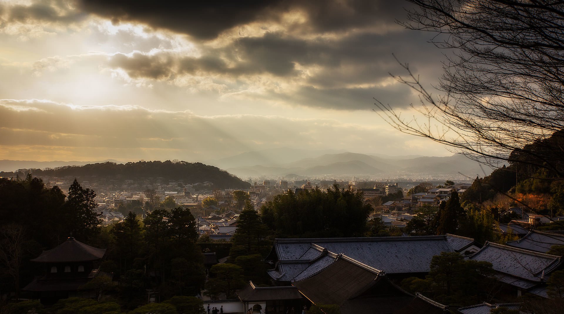 A cloudy sky over a city landscape.