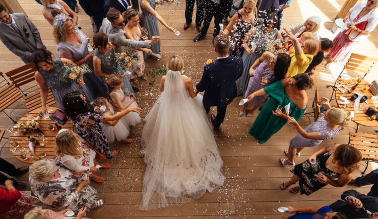 Mill Barns Shropshire Wedding Photographer capturing confetti being thrown at a wedding ceremony.