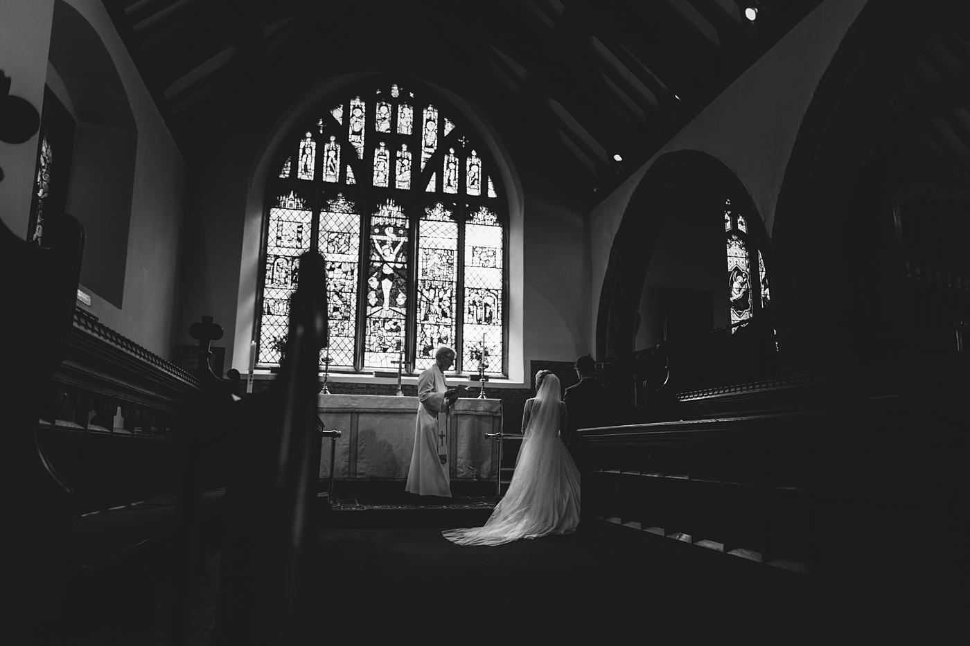 bride and groom led into prayer taken by North Wales Wedding Photographer Phil Barrett