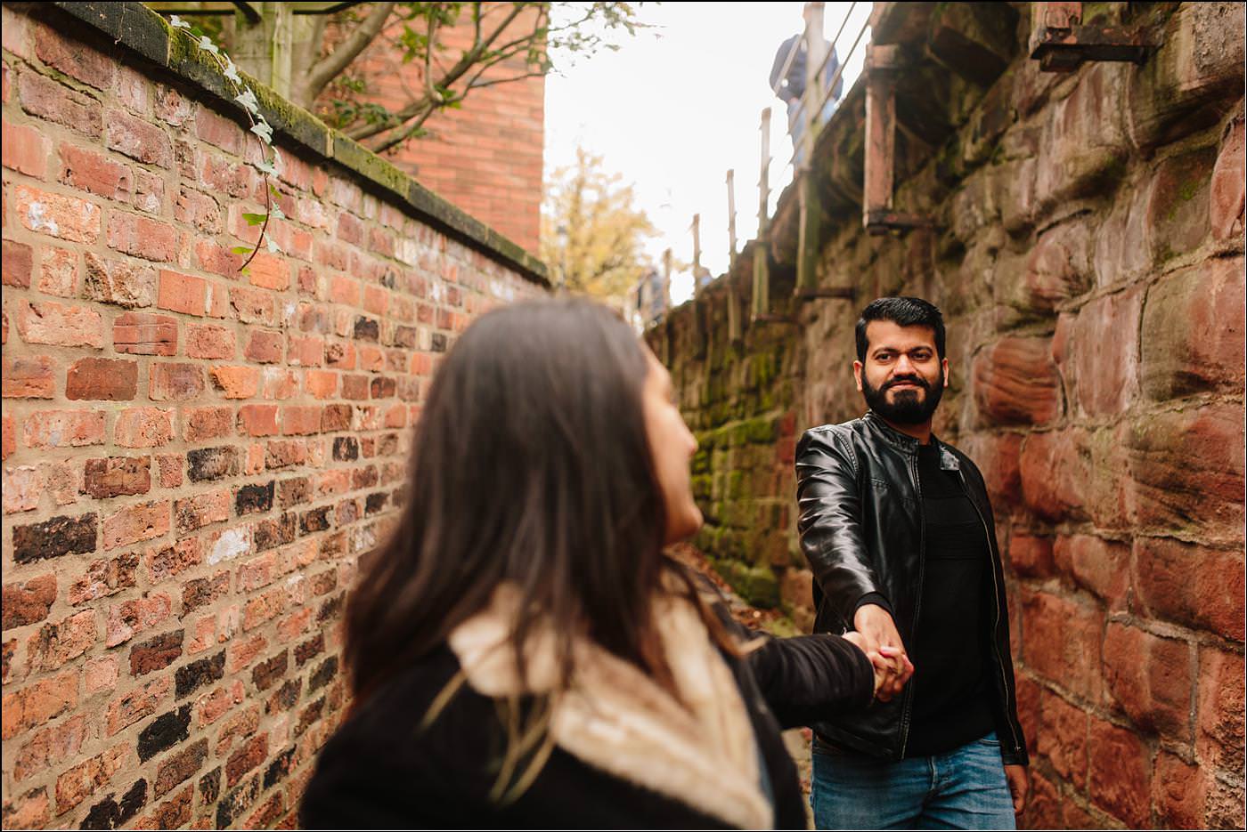 two guys walking through Chester with a wedding photographer in cheshire
