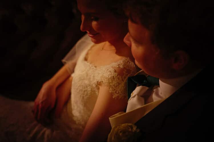 A bride and groom looking at each other in the dark at Tyn Dwr Hall.