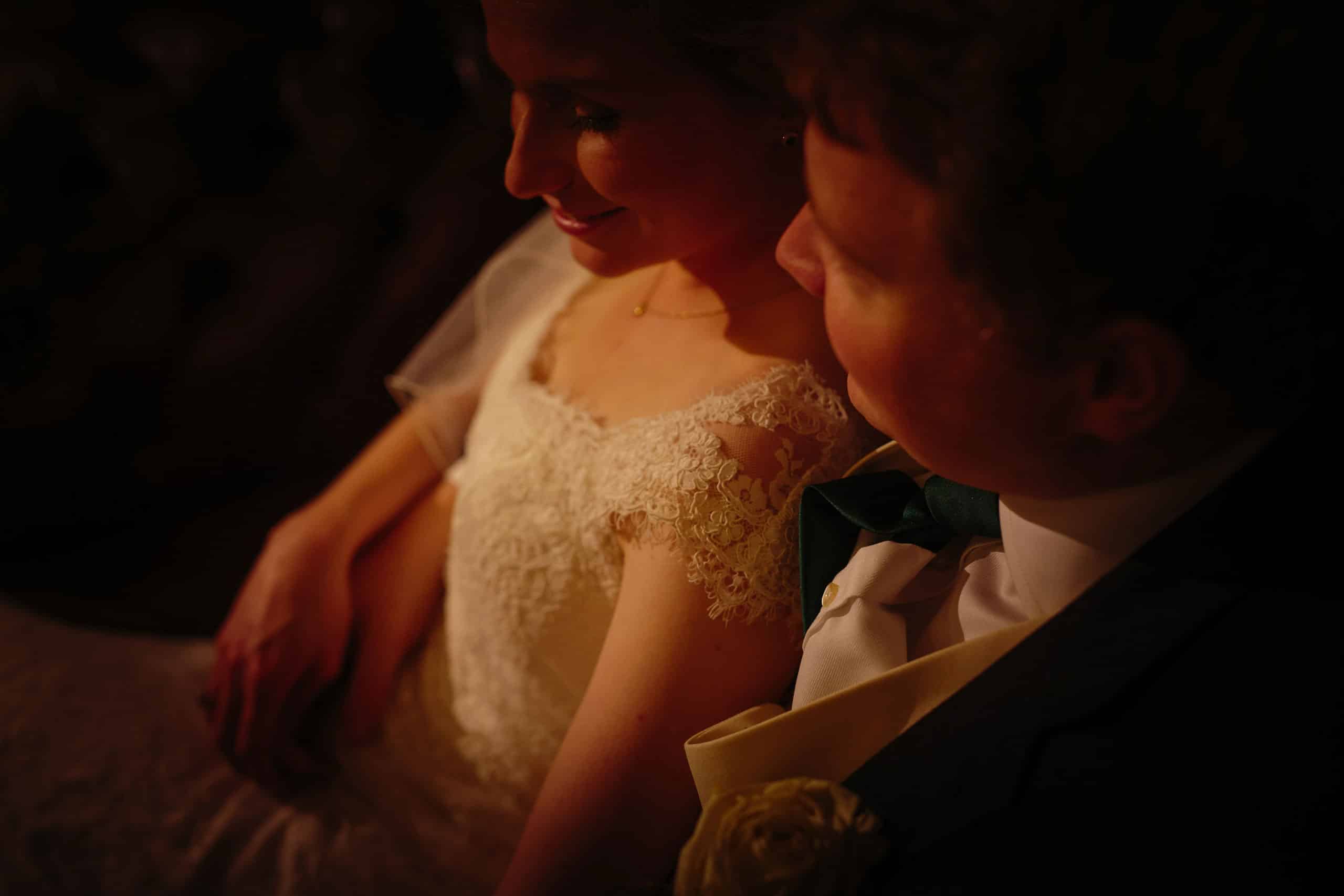 A bride and groom looking at each other in the dark at Tyn Dwr Hall.