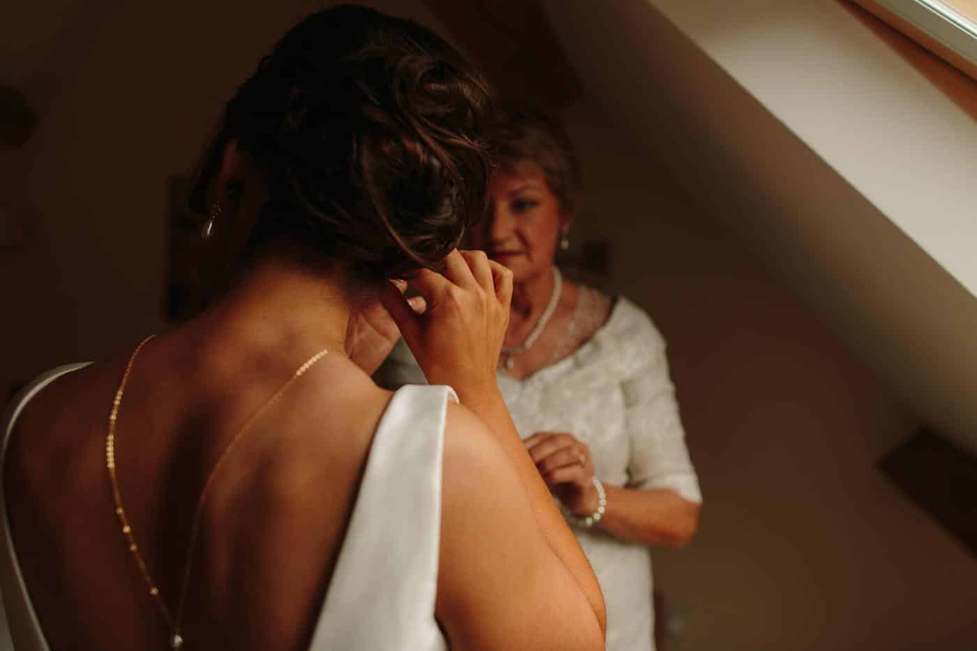 a bride fastening her earring