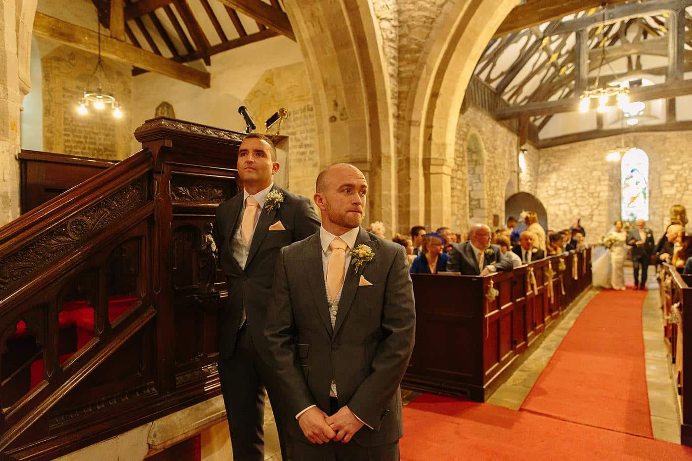 Two men standing on the steps of Wistanstow Village Hall, a wedding venue.