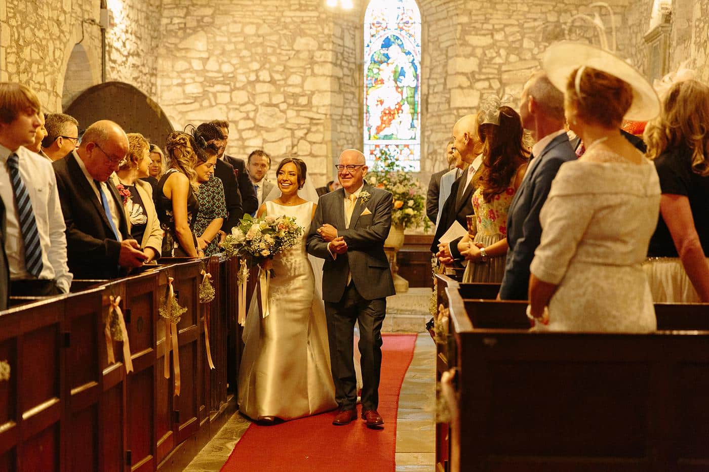 A bride and groom walking down the aisle at Wistanstow Village Hall wedding.