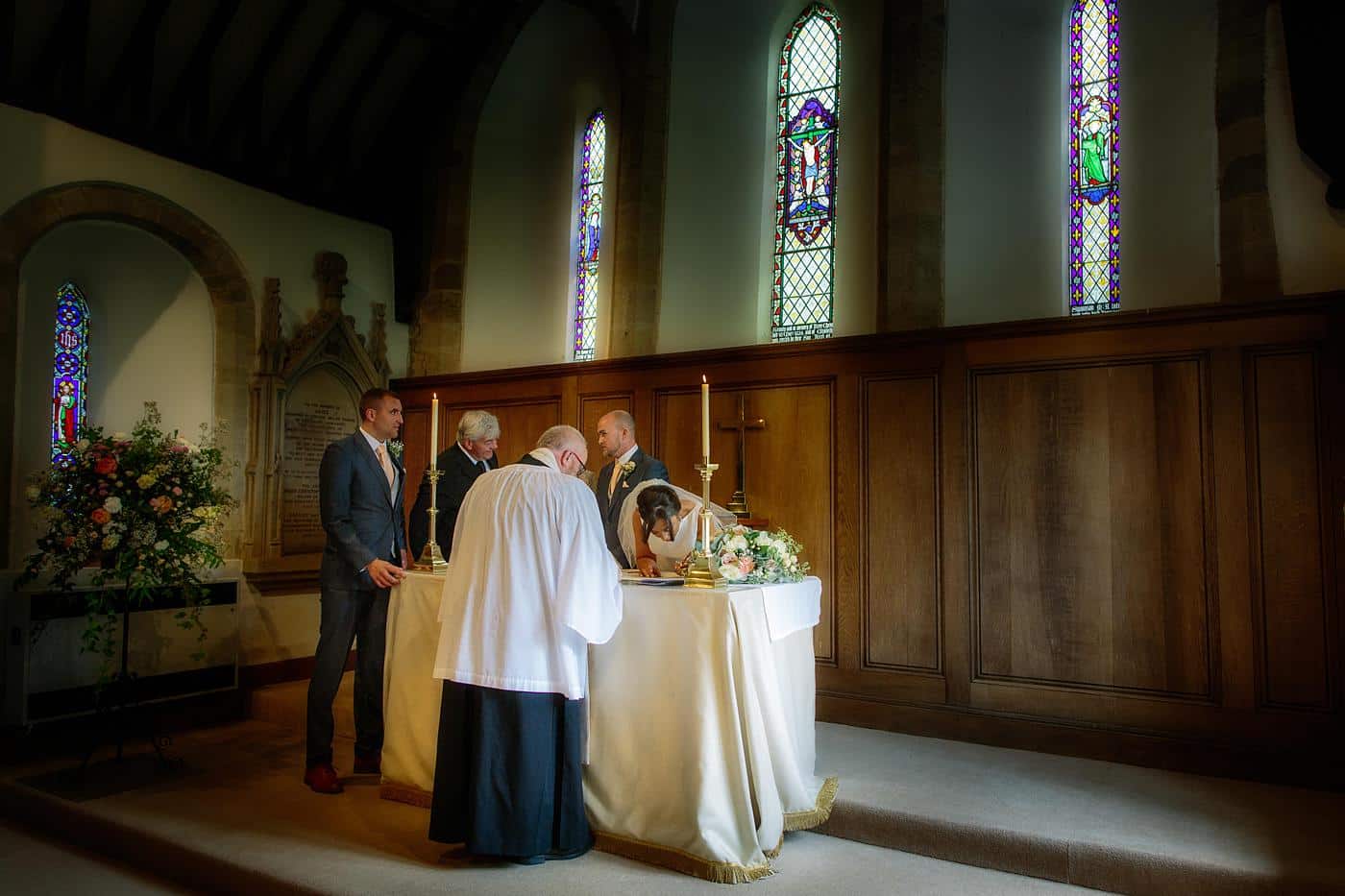 A wedding ceremony is taking place in Wistanstow Village Hall.