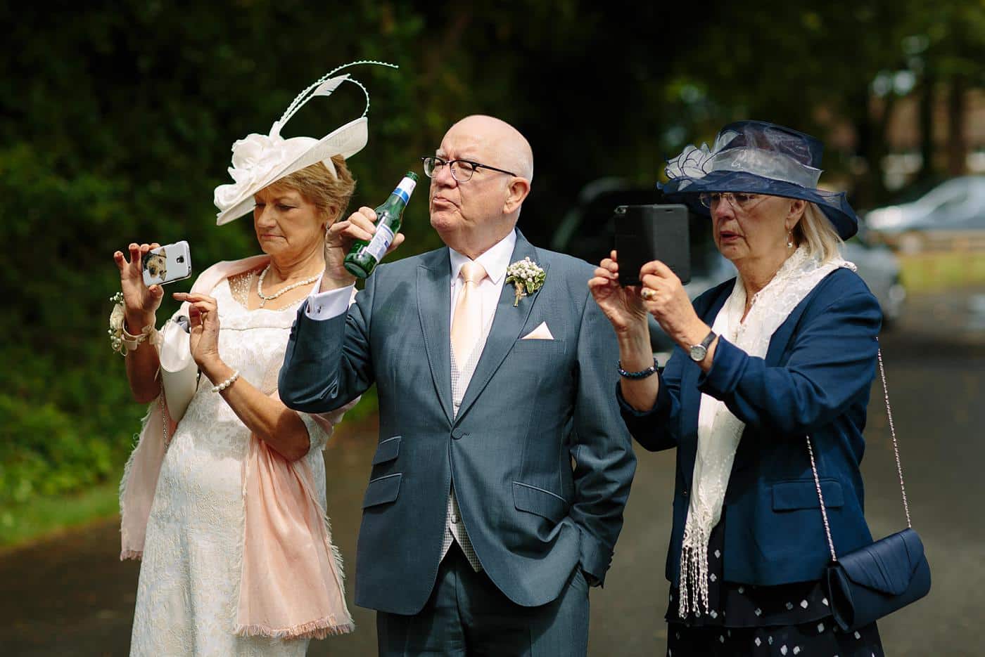 A group of people taking pictures at a Wistanstow Village Hall wedding.