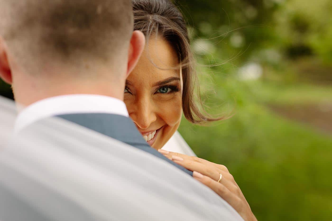 A Wistanstow Village Hall wedding captured the joyous moment of a beaming bride and groom smiling at each other.