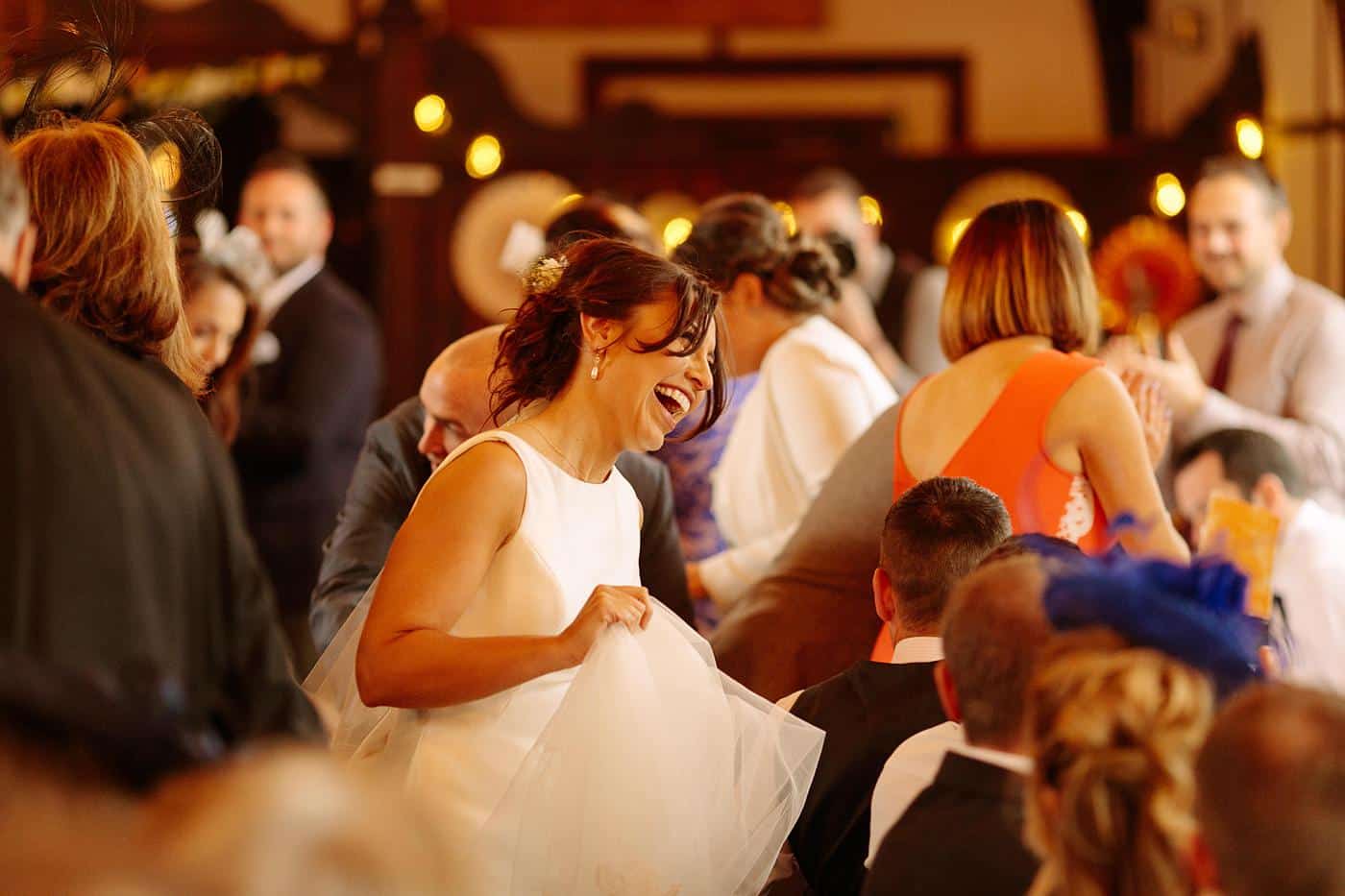 A bride and groom laughing at a Wistanstow Village Hall wedding reception.