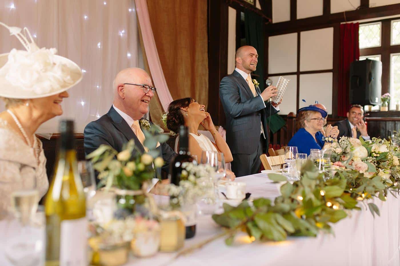 A group of people sitting at a table at a Wistanstow Village Hall wedding reception.