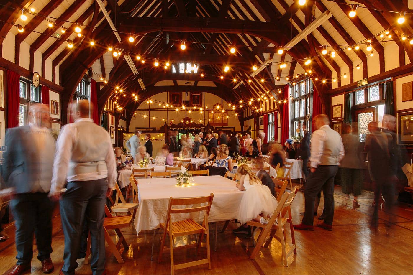 A Wistanstow Village Hall wedding with people sitting around tables.