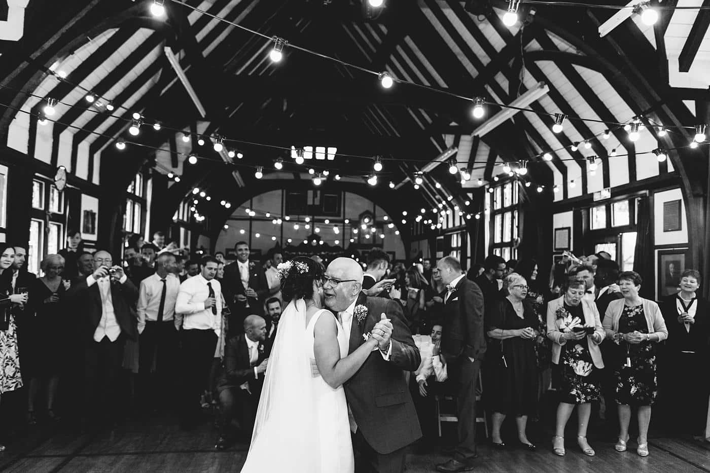 A black and white photo of a bride and groom sharing their first dance at a Wistanstow Village Hall Wedding.