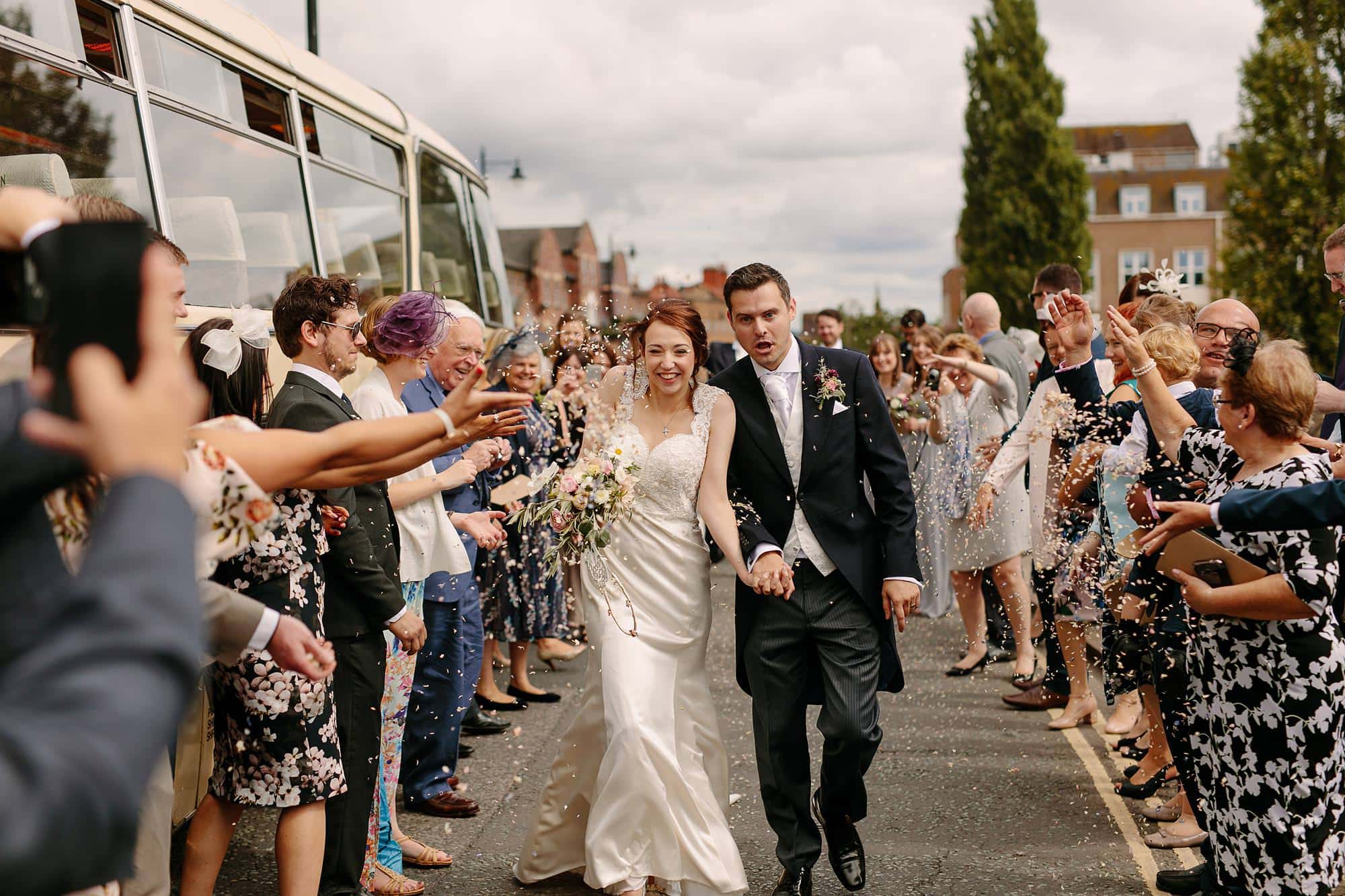 bride and groom run through confetti at Shrewsbury wedding