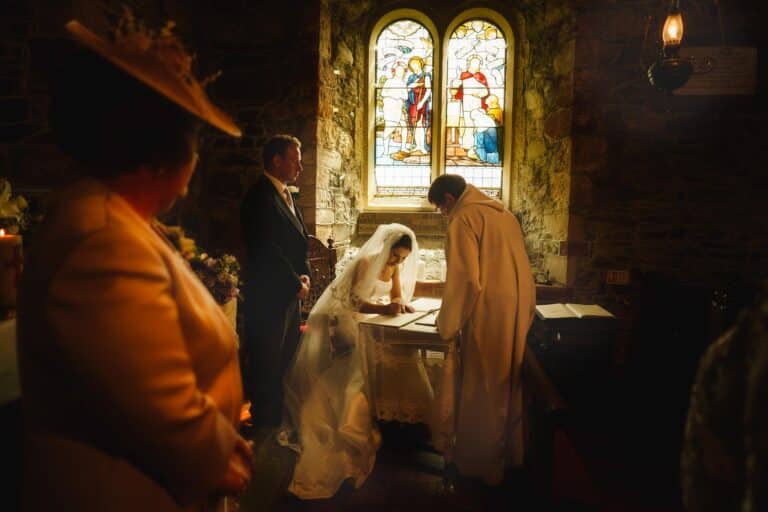 Bride signing the marriage certificate captured by Shropshire wedding photographer PbArtWorks