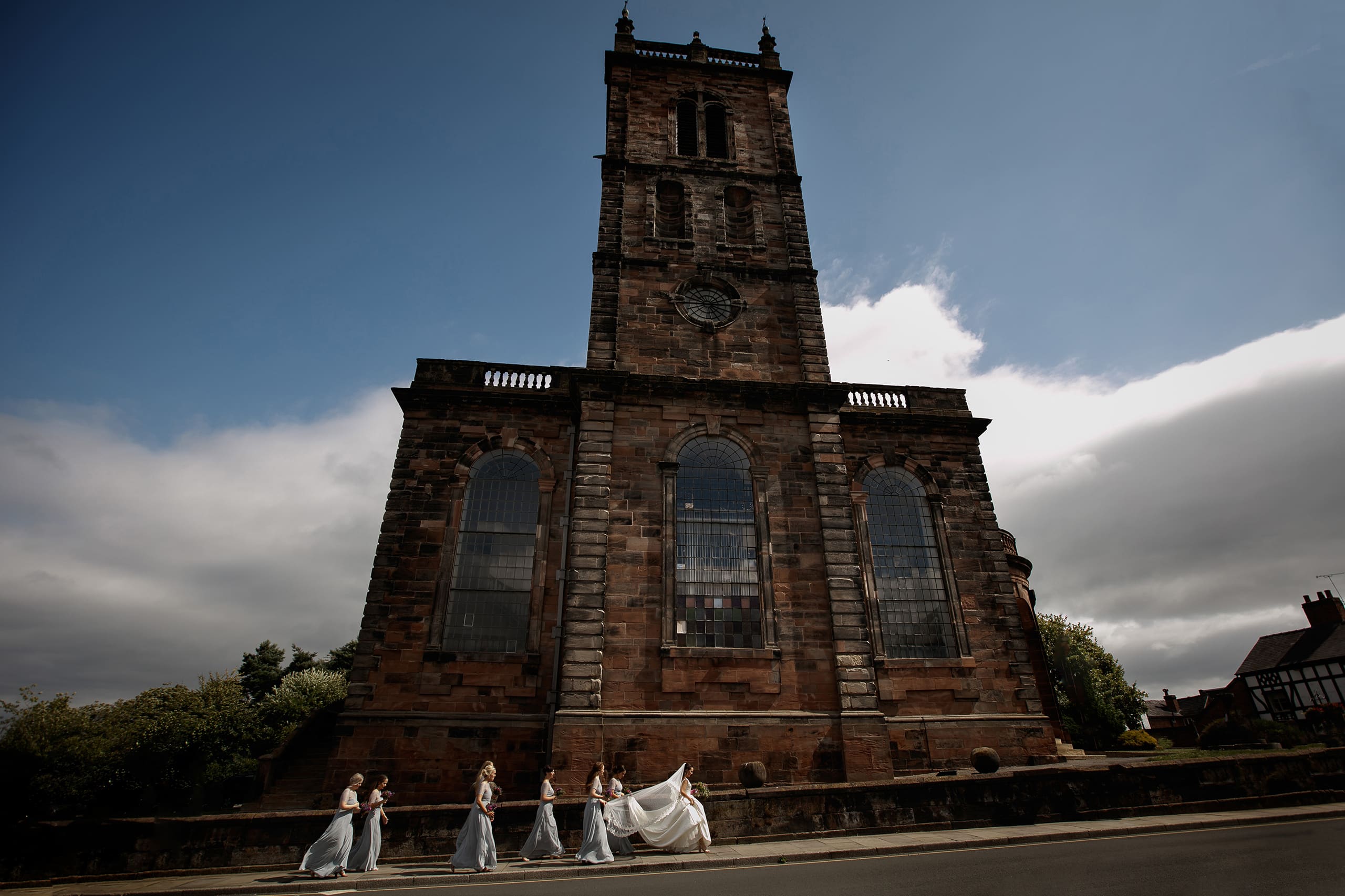Shropshire wedding photographer captures bridal party walking to church in Whitchurch