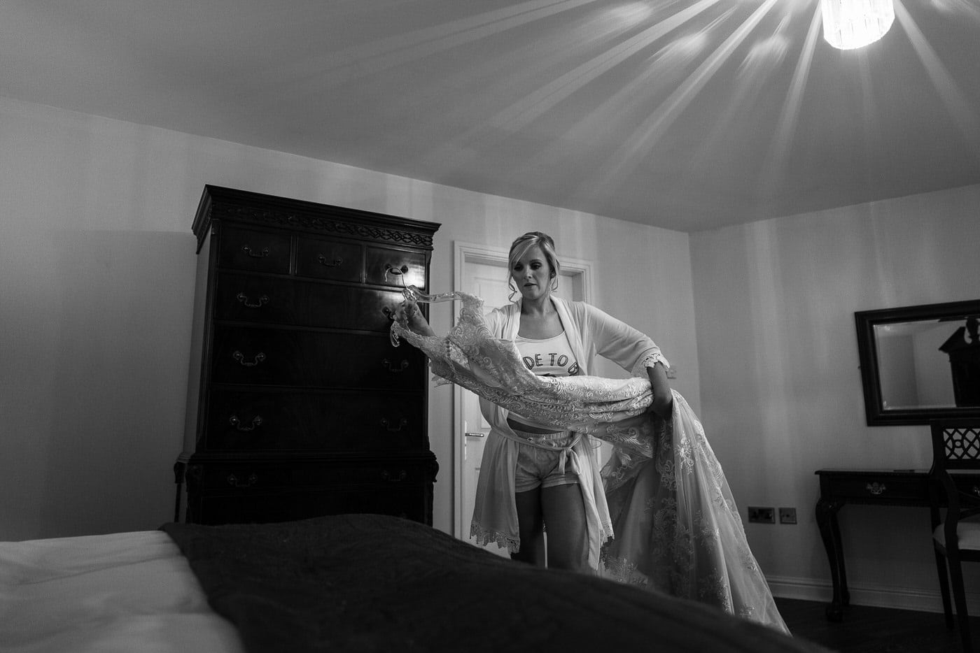 the beautiful bride prepares her dress at Netley Hall in Shropshire