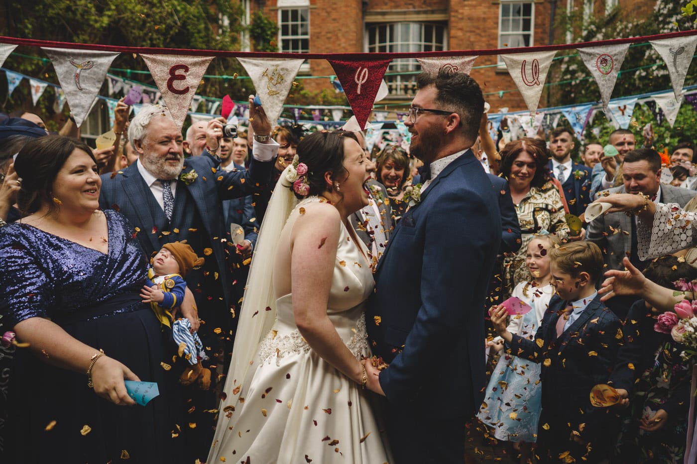 A Walcot Hall wedding ceremony is transformed into a joyous celebration as confetti rains down on the beaming bride and groom.