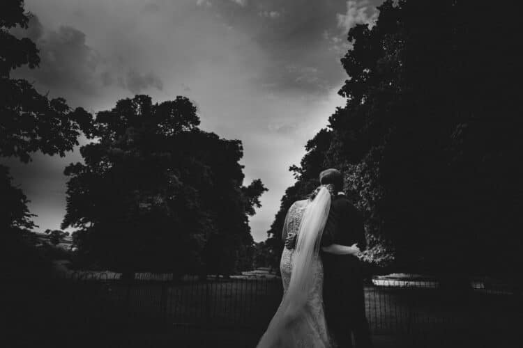 bride and groom share a quiet moment in front of the trees at Rowton Castle