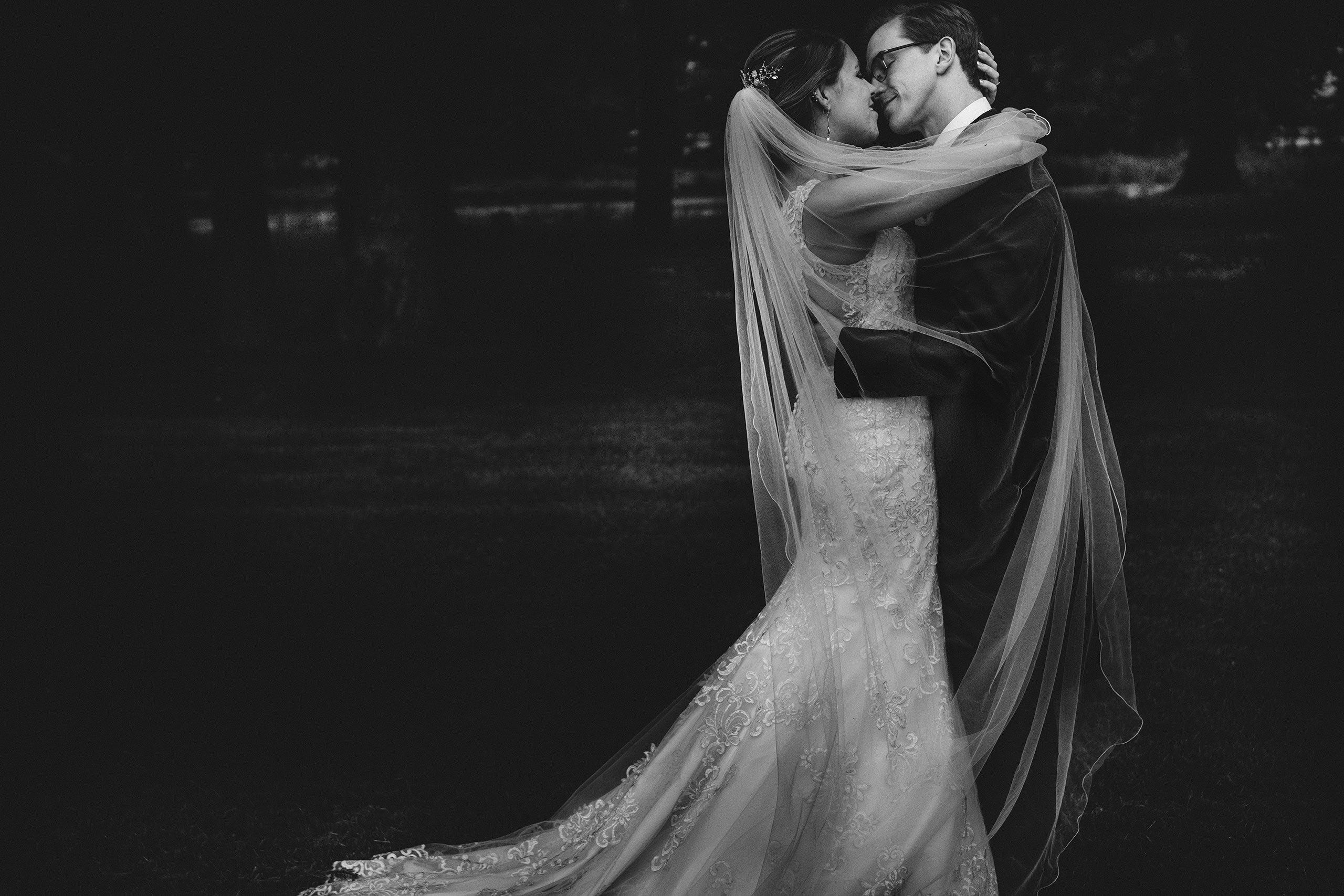 the newlyweds share an embrace in the grounds of Rowton Castle