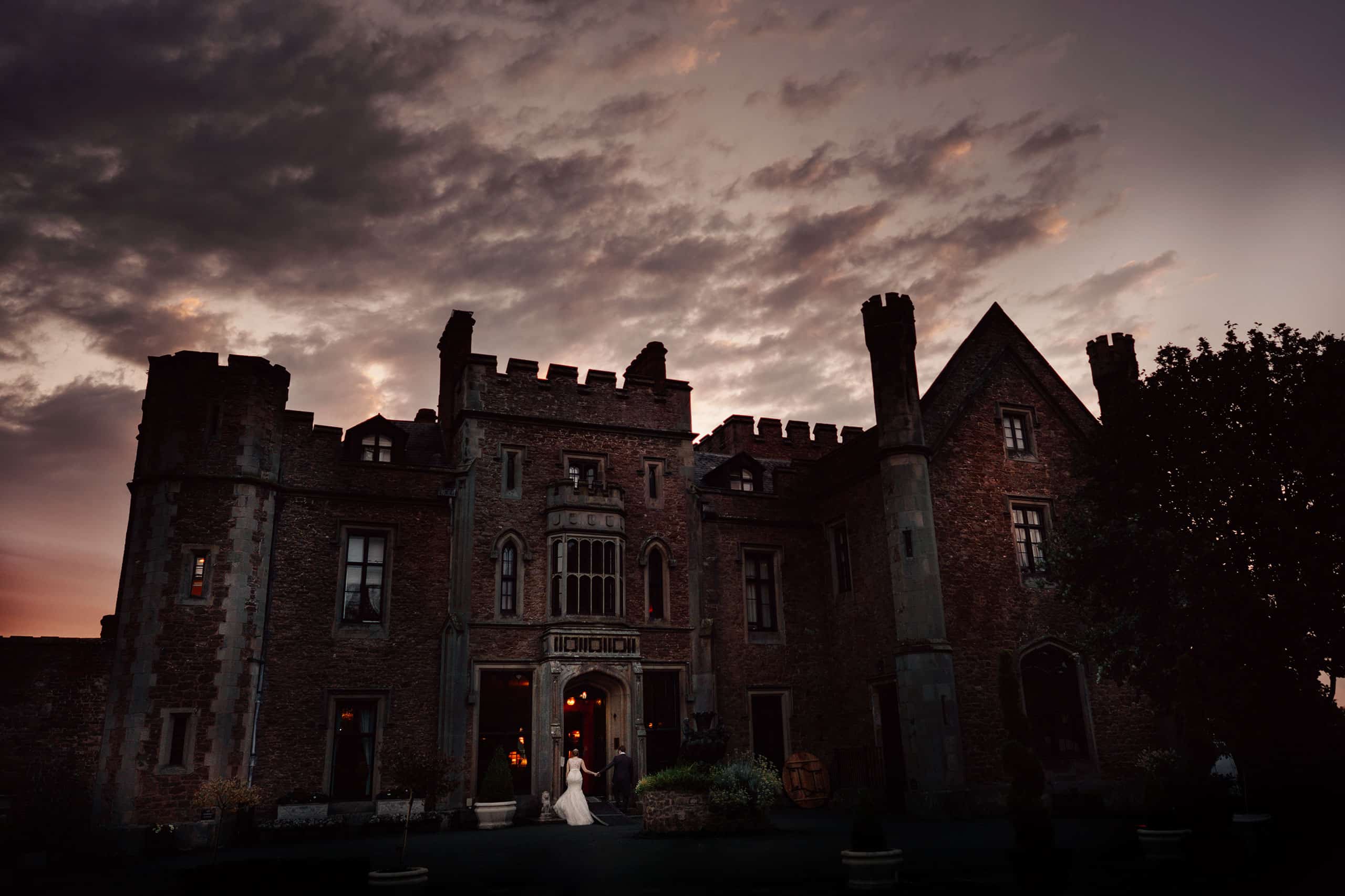 the bride and groom walking back to their wedding reception at Rowton Castle