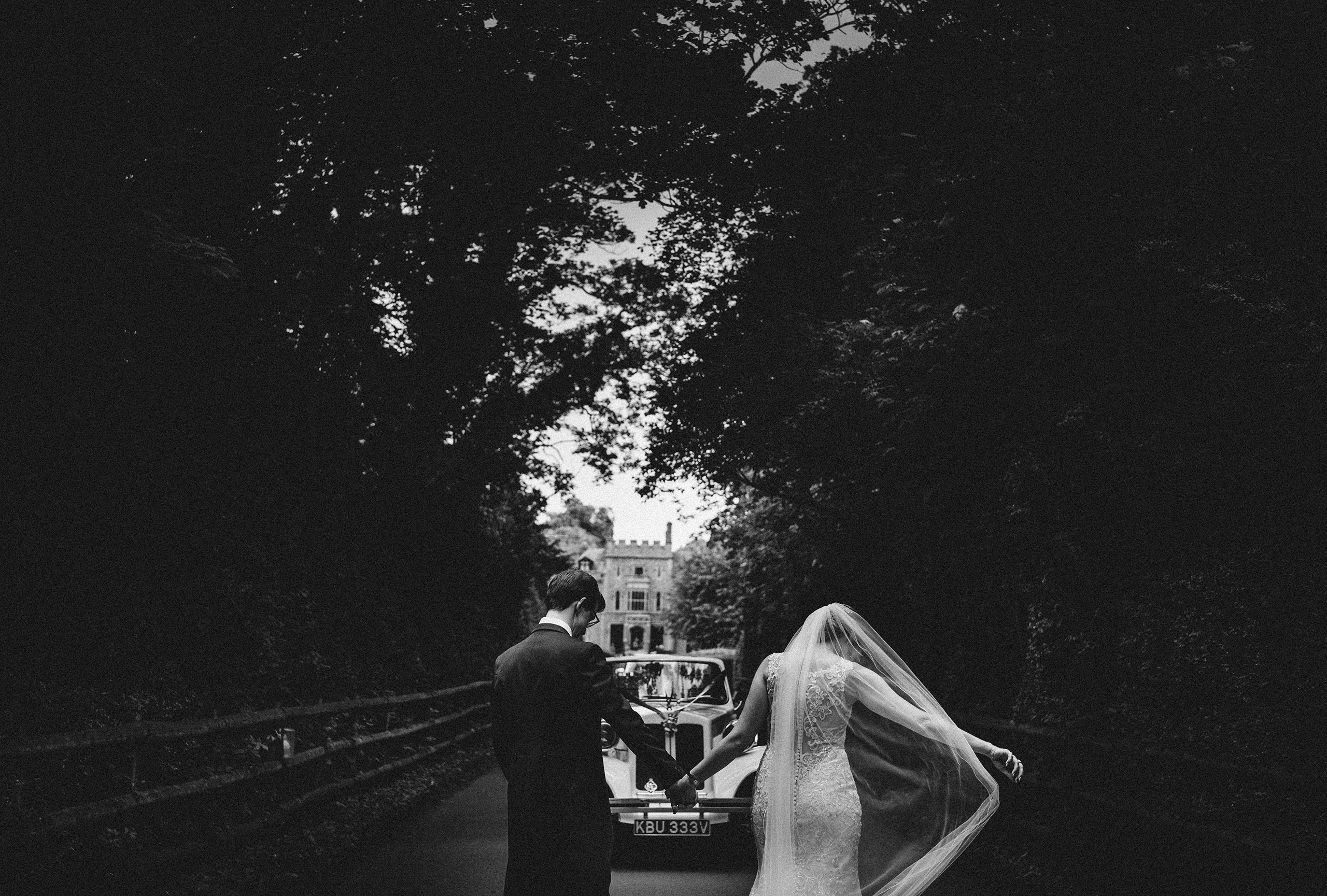 rowton castle provides the perfect backdrop as the bride and groom make their way to the wedding car