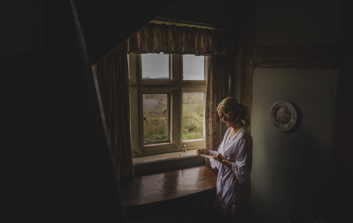 bride reading note at her soulton hall wedding day