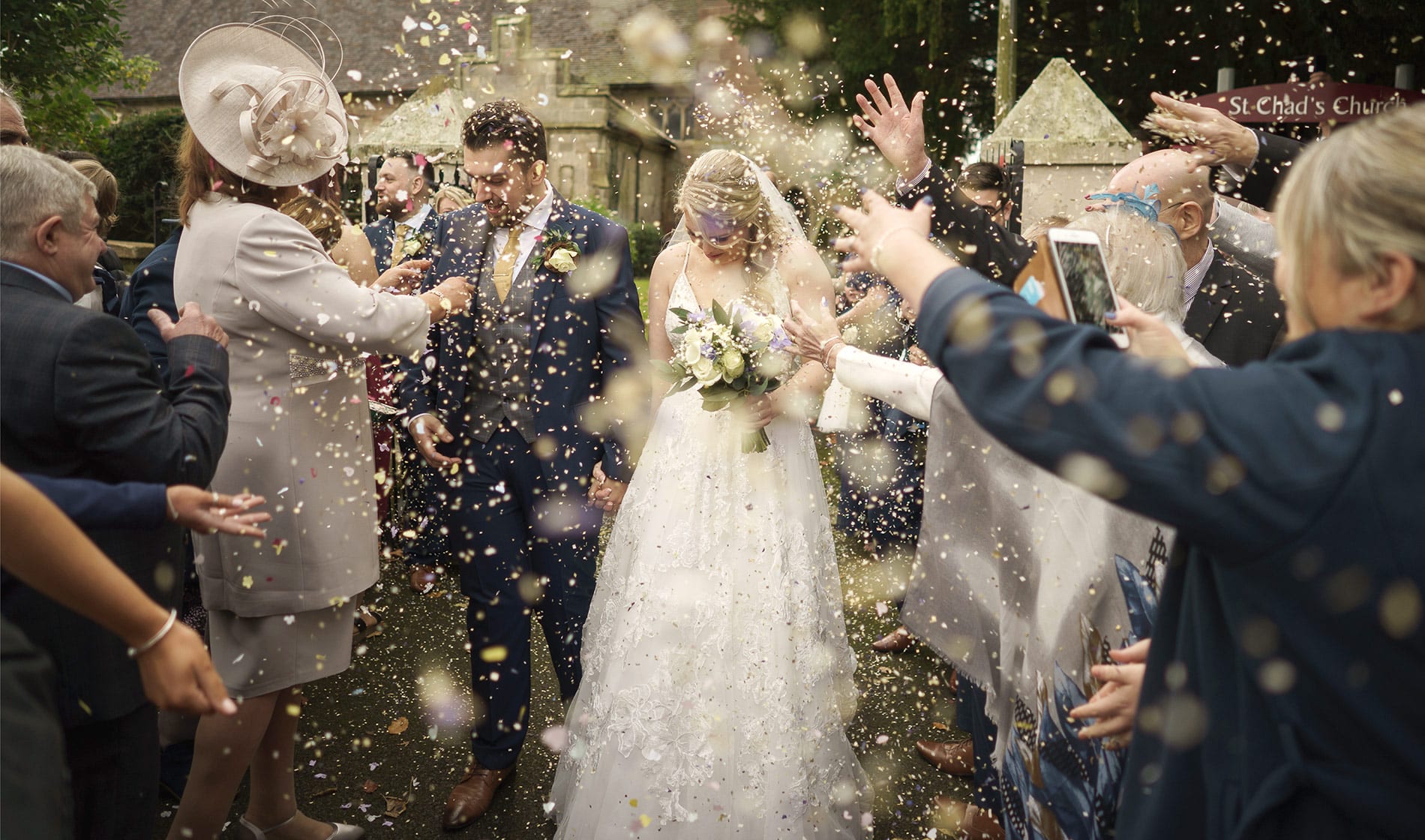 bride and groom in confetti after getting married in a shropshire church