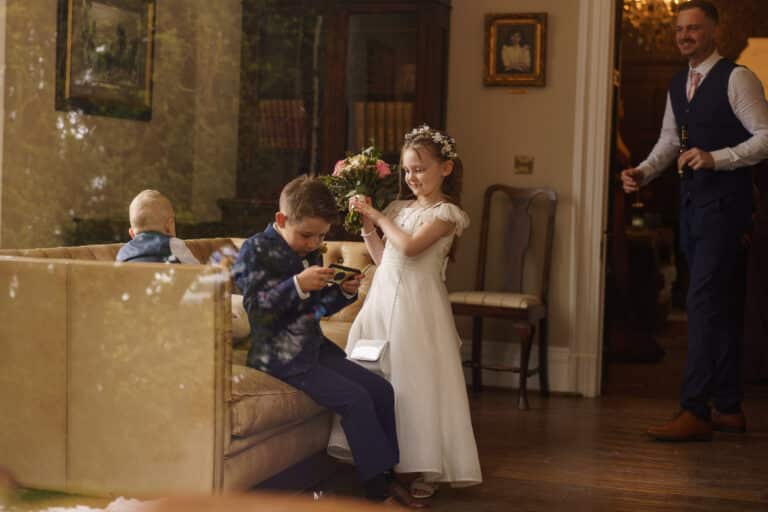 A group of children are playing in a living room decorated for a winter wedding at Tyn Dwr Hall.