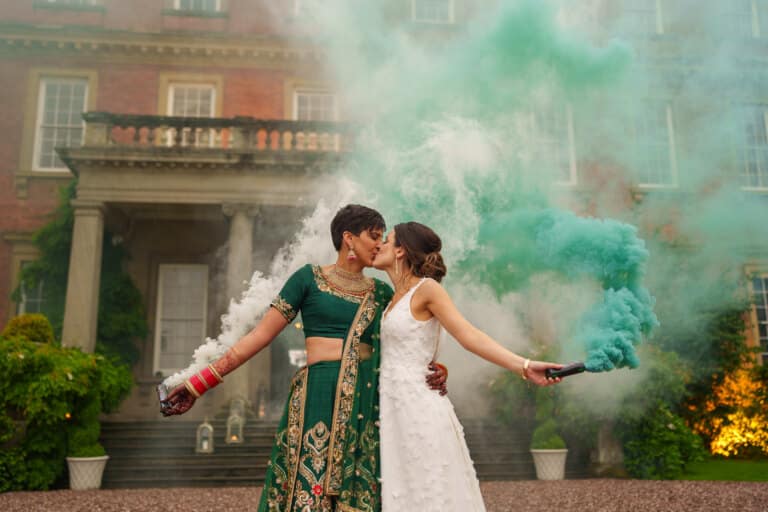 Two brides with smoke bombs in front of a Davenport House PbArtWorks Photography, a Shropshire wedding photographer.