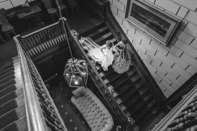 A black and white Davenport House wedding photo of a bride on a staircase.