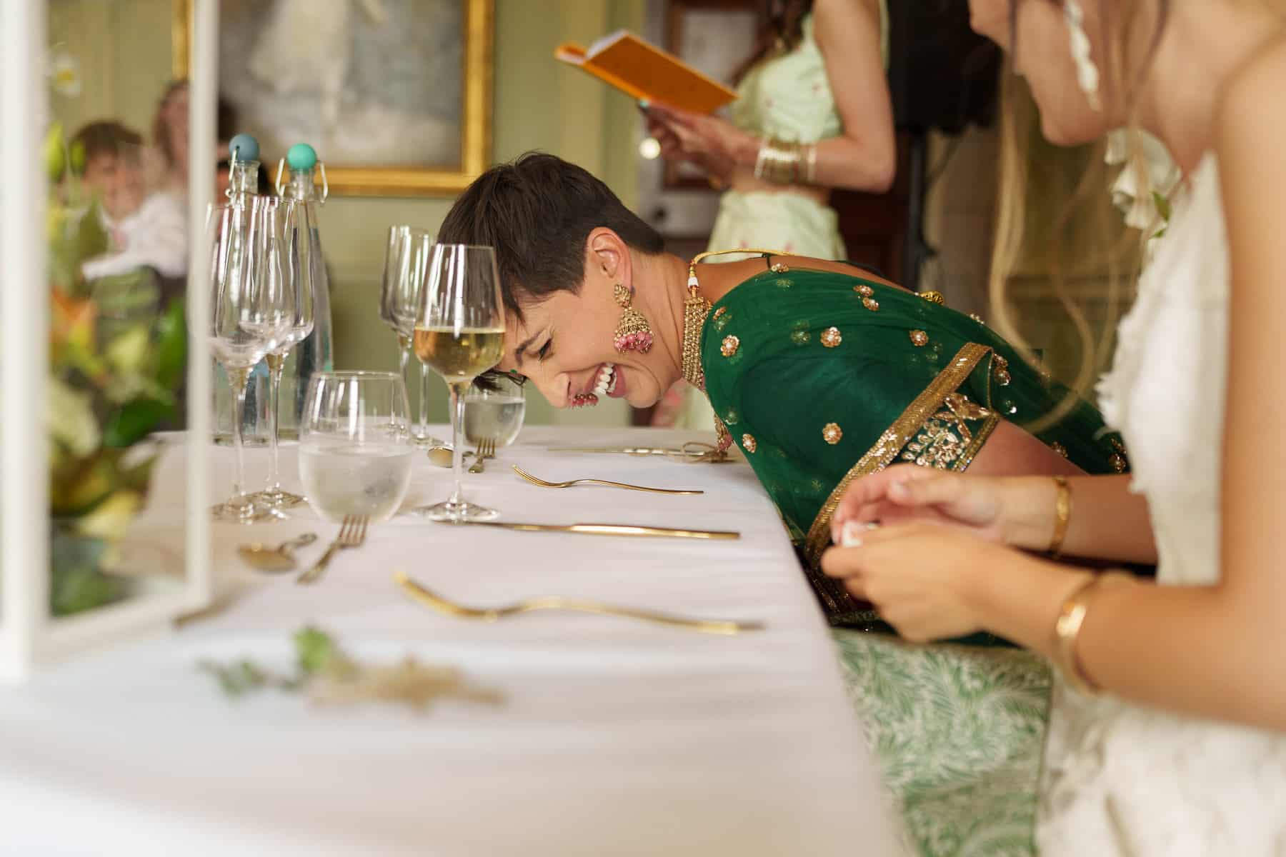 A couple joyfully laughing at a Davenport House wedding dinner table.