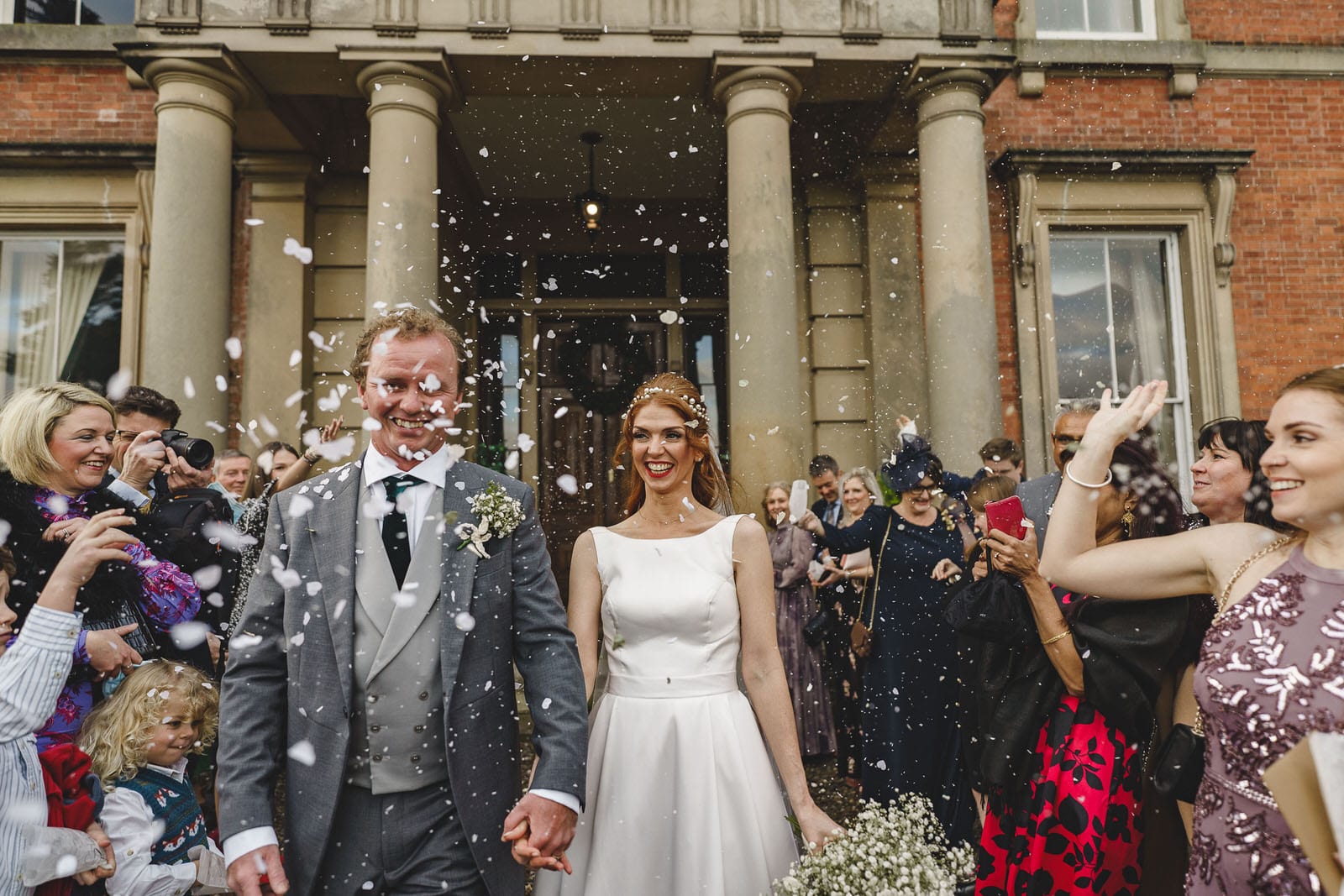 a bride and groom are surrounded by confetti at their wedding.