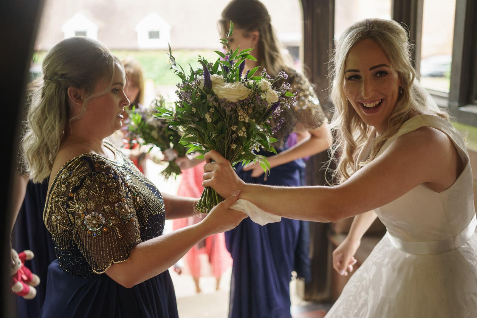 a bride and her bridesmaids are holding bouquets.
