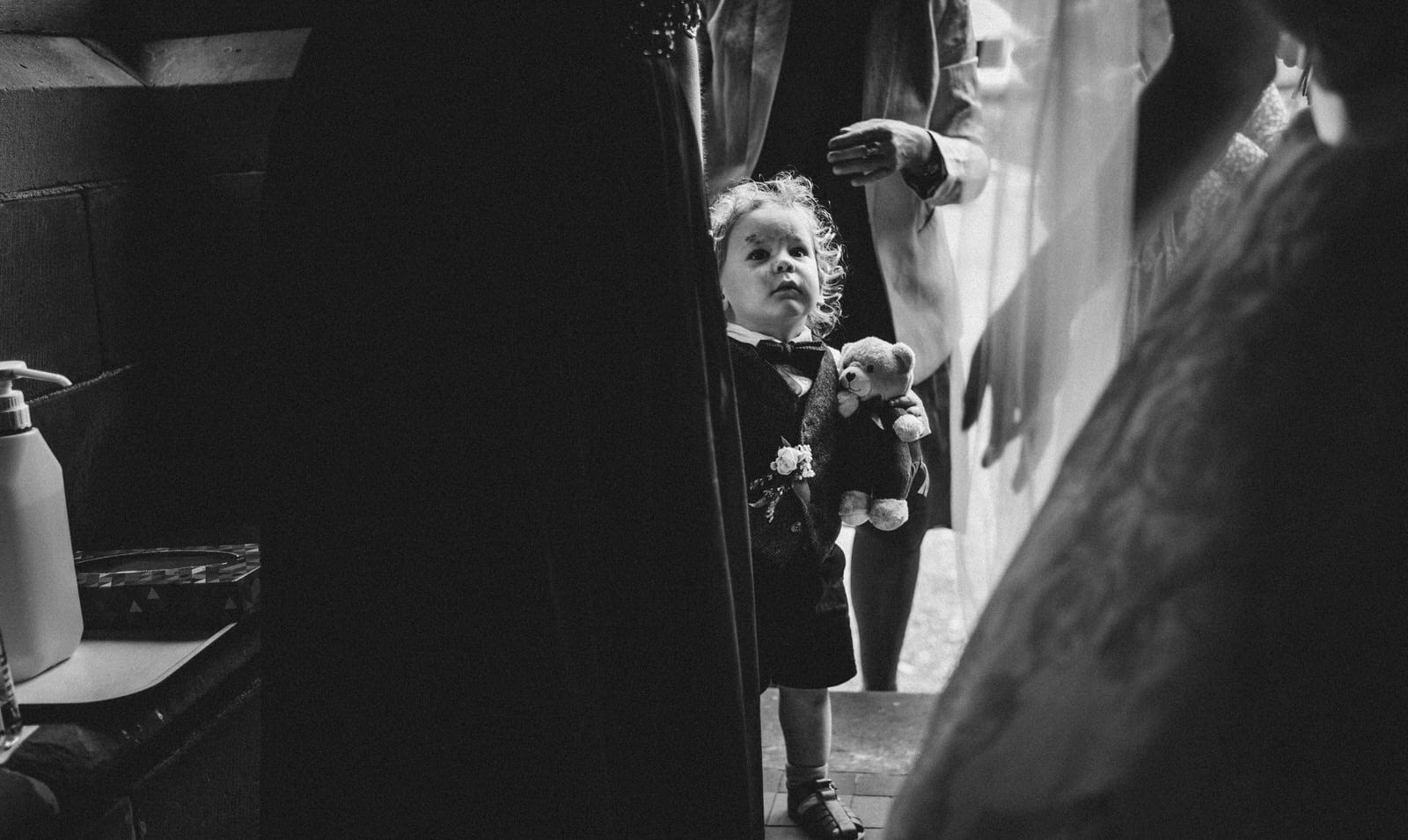 black and white photo of a bride getting ready in a church.