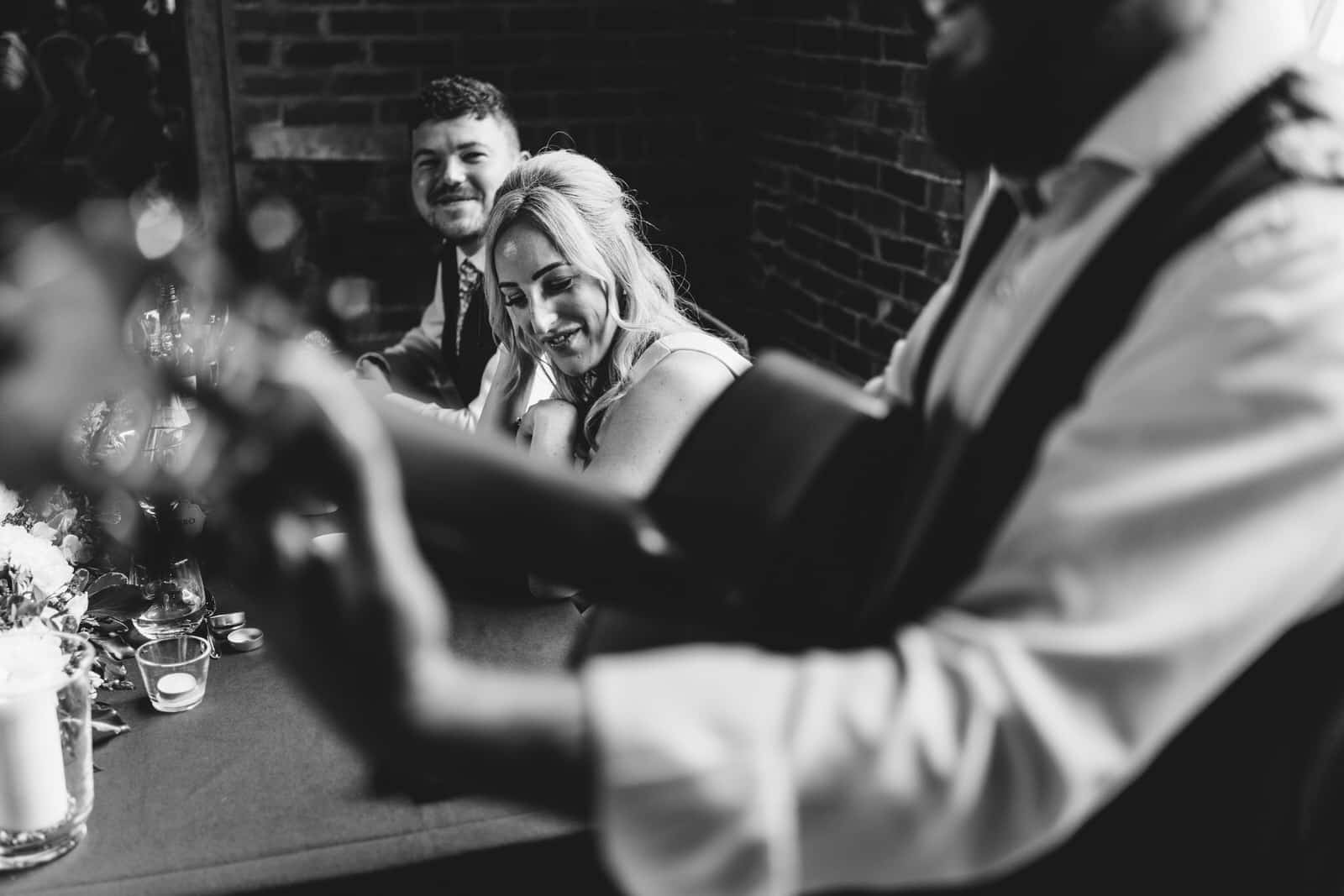 a black and white photo of a group of people at a table.