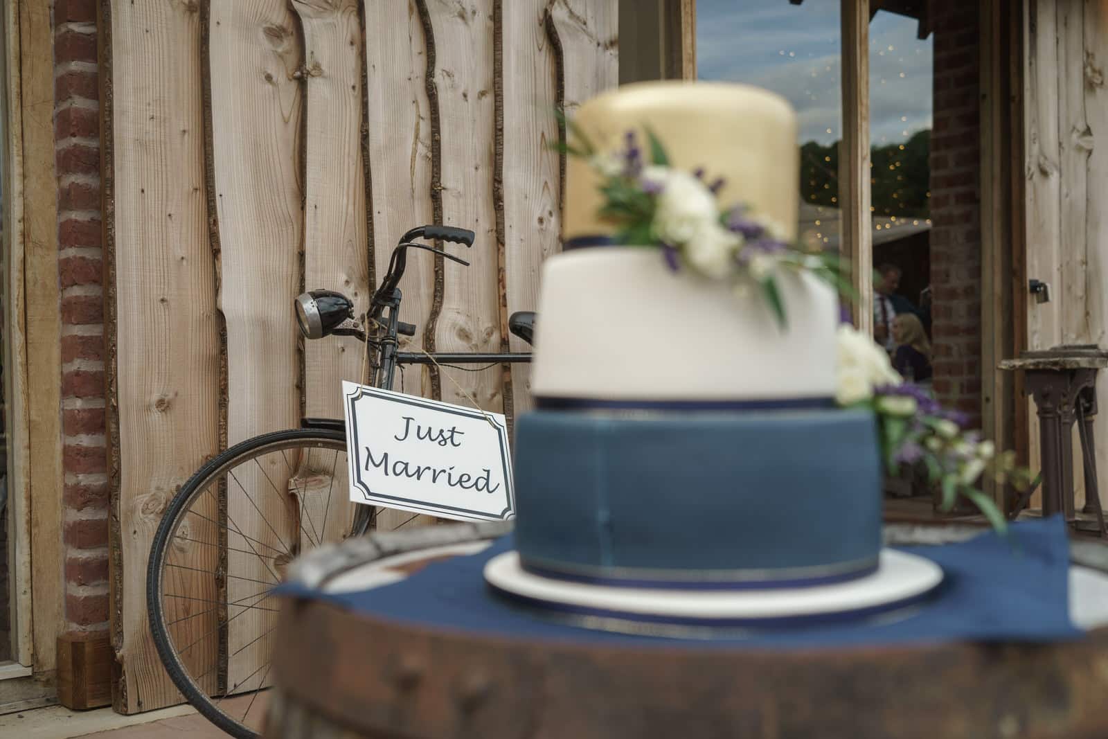 a wedding cake on a wooden table.