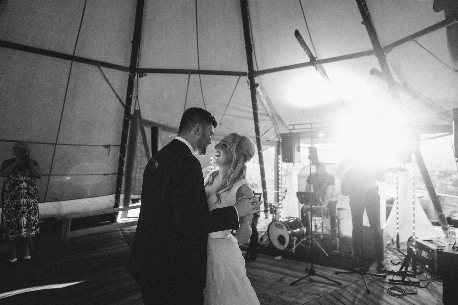 a bride and groom dance in a tepee tent.