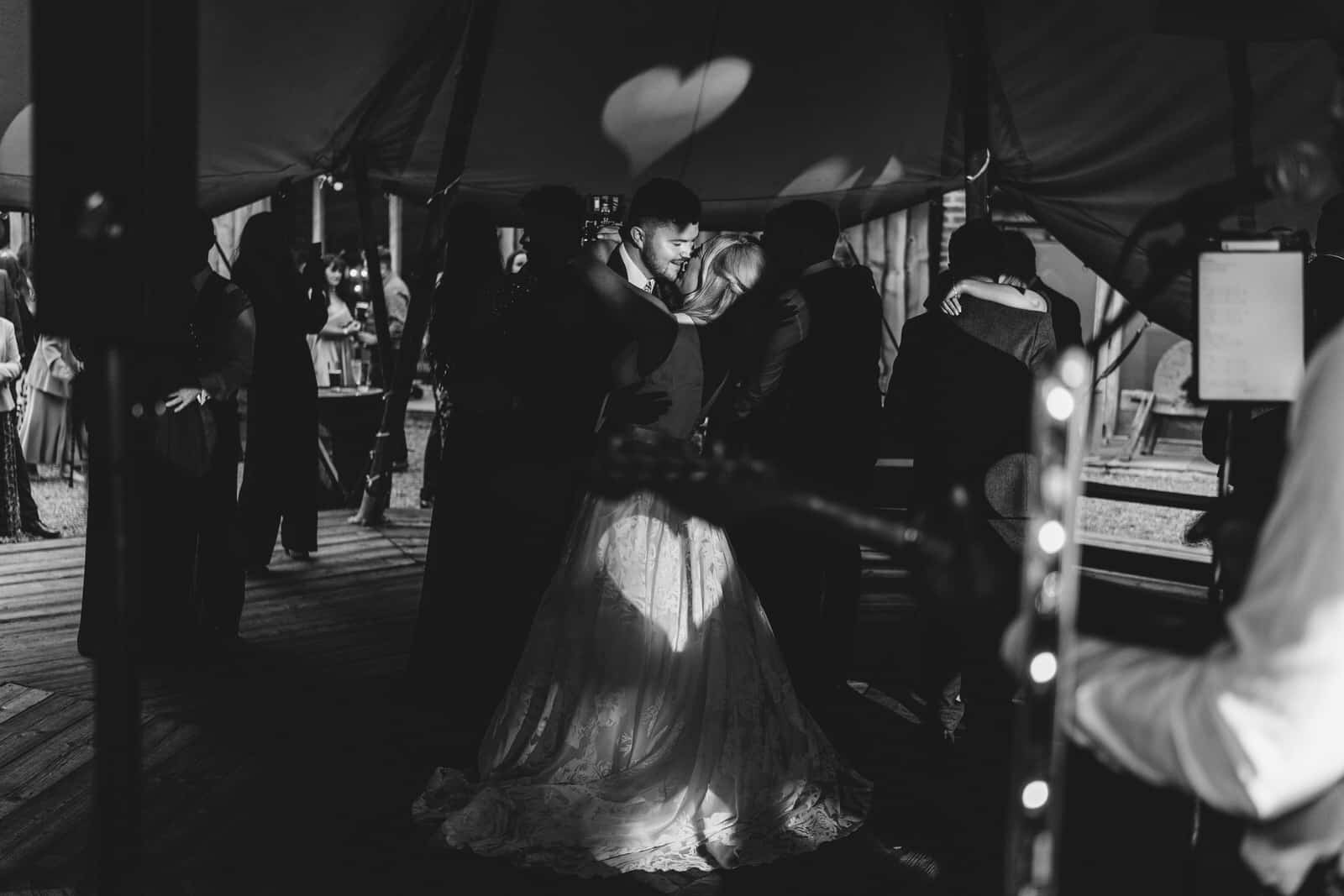 a bride and groom dance in a tipi.