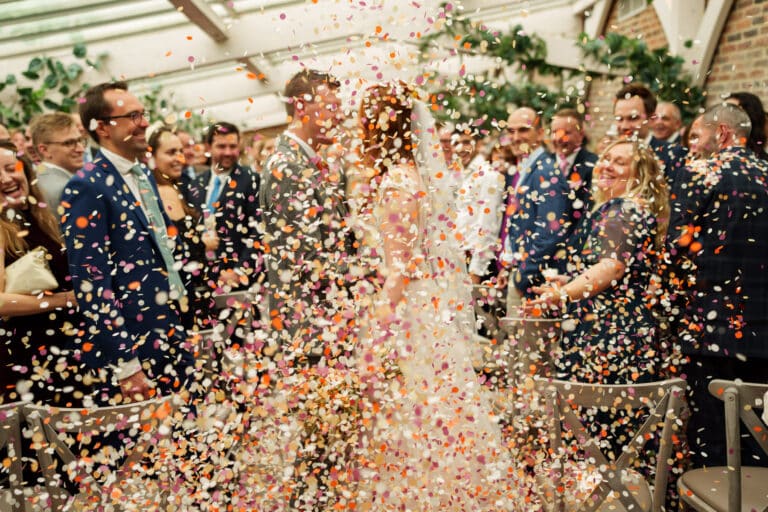 confetti being thrown at a wedding ceremony.