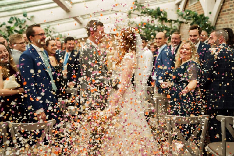 confetti being thrown at a wedding ceremony.