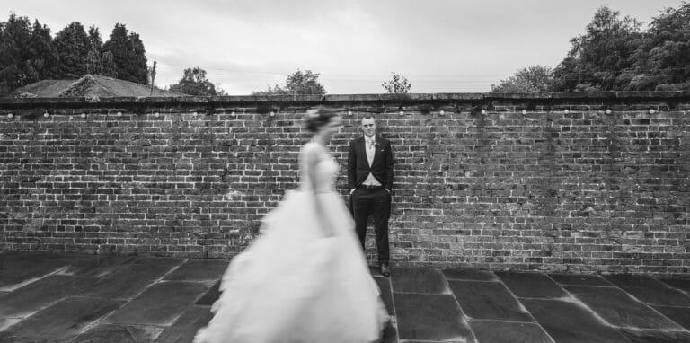 a bride and groom standing in front of a foxtail barn.