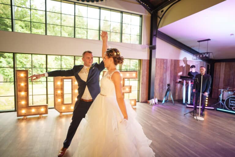 a bride and groom dancing at their wedding reception at foxtail barns.