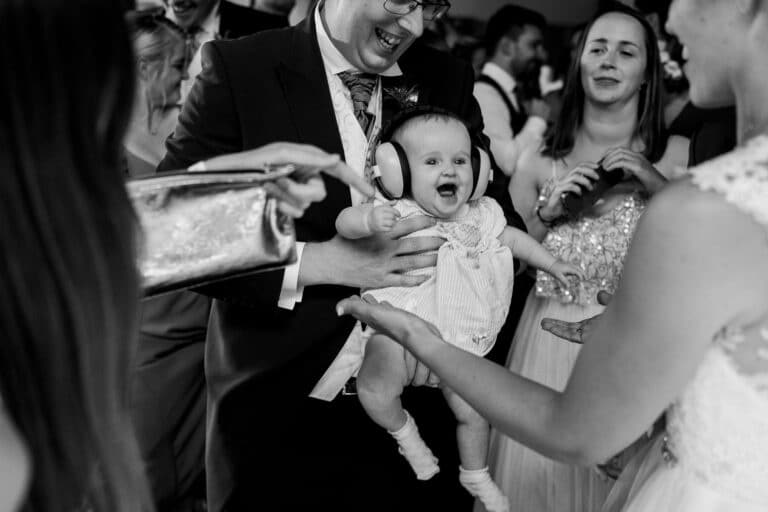 a man is holding a baby in his foxtail arms.