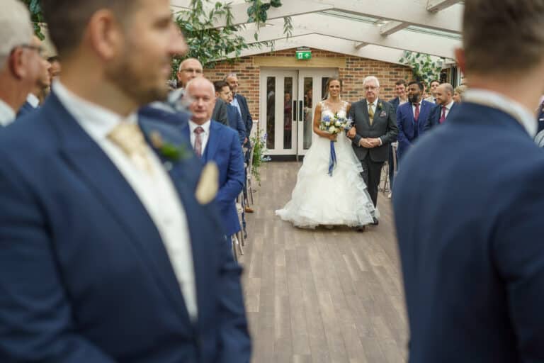 a bride and groom walking down the aisle at the foxtail barns wedding venue.