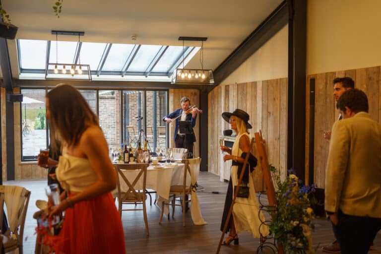 a group of people standing in a foxtail barn.