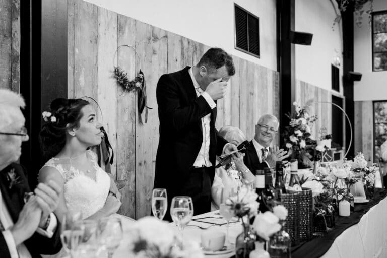 a black and white photo of a bride and groom at a wedding reception at foxtail barns.