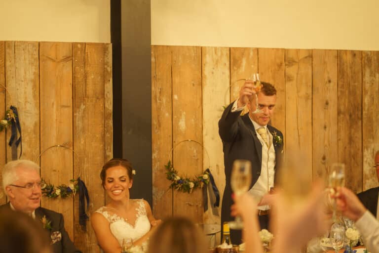 a bride and groom toasting at their foxtail barns wedding reception.
