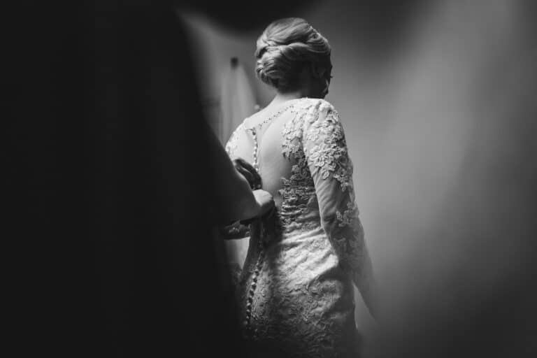 a bride is getting ready in her wedding dress at foxtail barns.