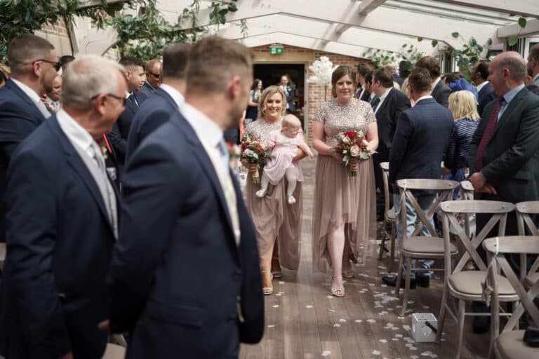 a bride and groom walking down the aisle at a foxtail barns wedding.