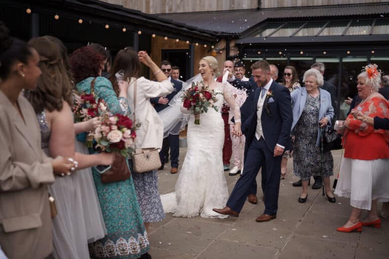 a bride and groom celebrating their special day at a foxtail barn wedding, gracefully walking down the aisle.